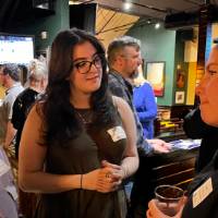 Three alums talking at the event.